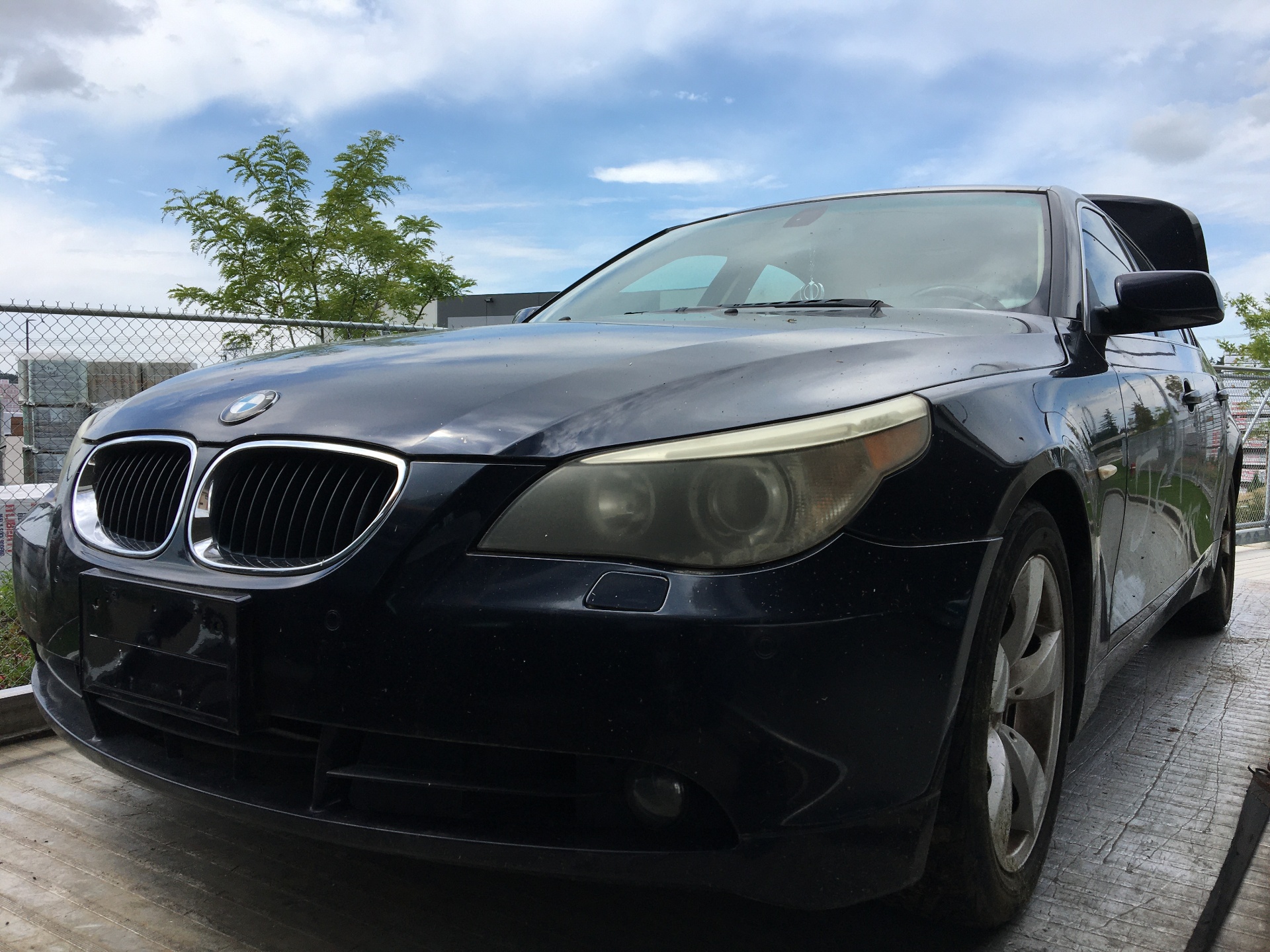 BMW 5 Series on a flatbed deck ready for pickup in Burnaby