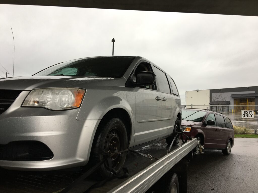 junk car removal Surrey BC van loaded on tow truck rainy day